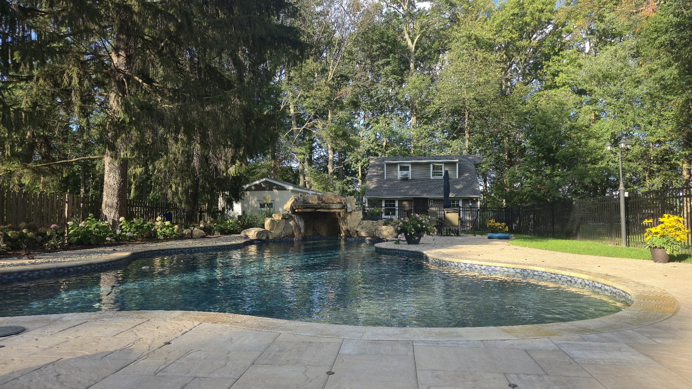 Pool with paver patio and landscaping